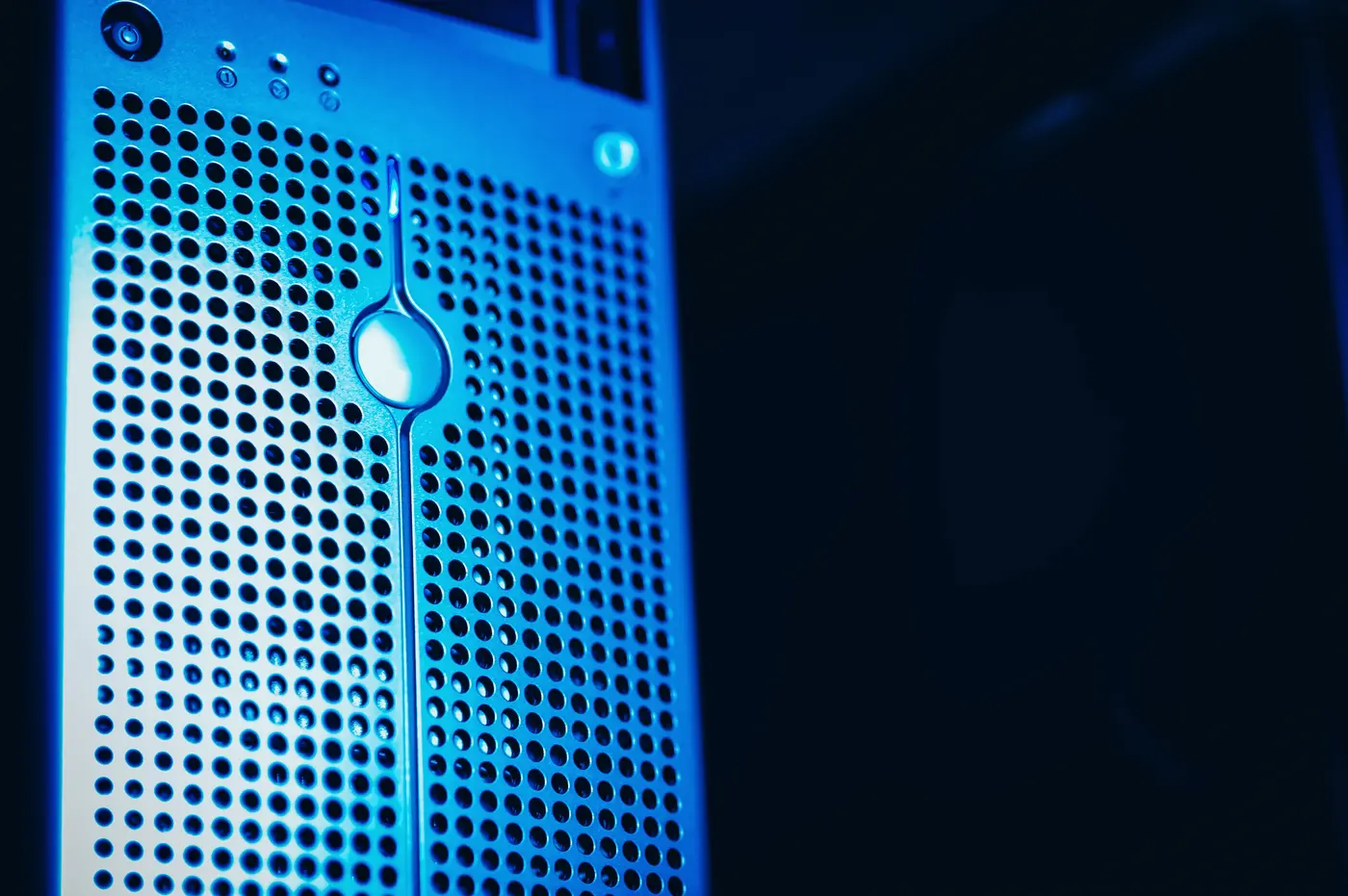 A server appliance lit in blue inside a rack